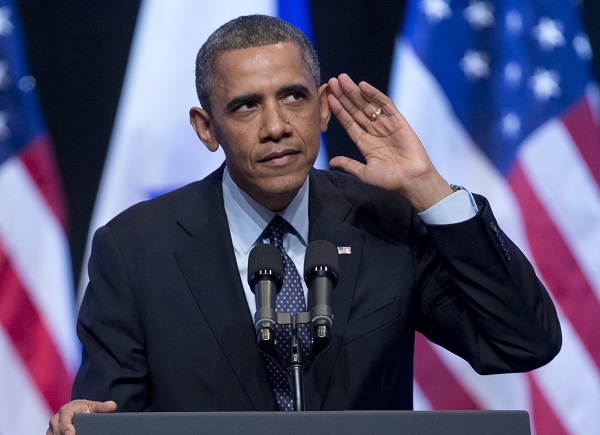 President Barack Obama looks into the crowd and tries to hear a person yelling at him during his speech at the International Convention Center in Jerusalem, Thursday, March 21, 2013. (AP Photo/Carolyn Kaster)